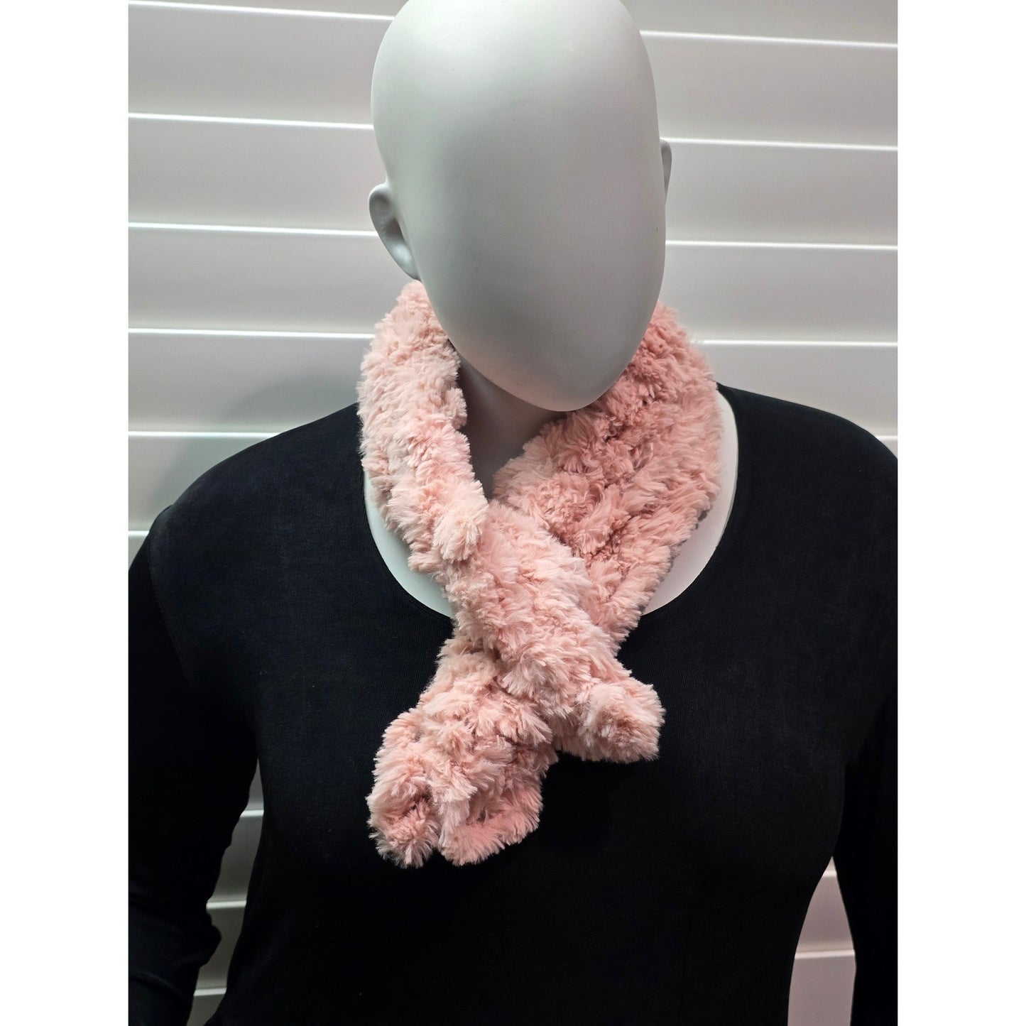 Short pink fuzzy scarf looped at the neck