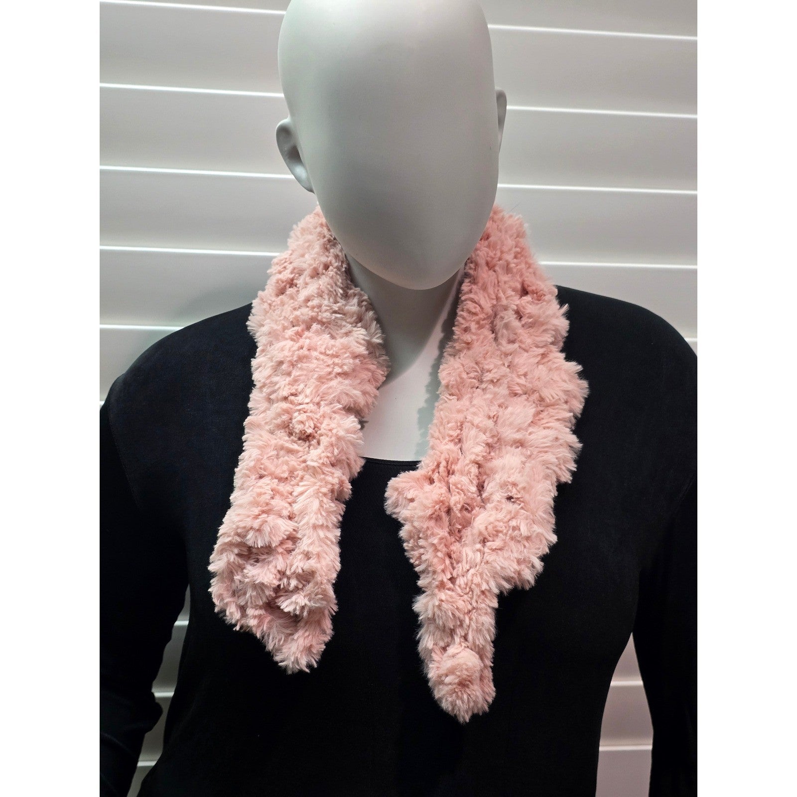 Short pink fuzzy scarf worn on mannequin